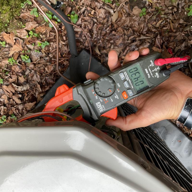 HVAC outdoor unit electrical testing with clamp meter
