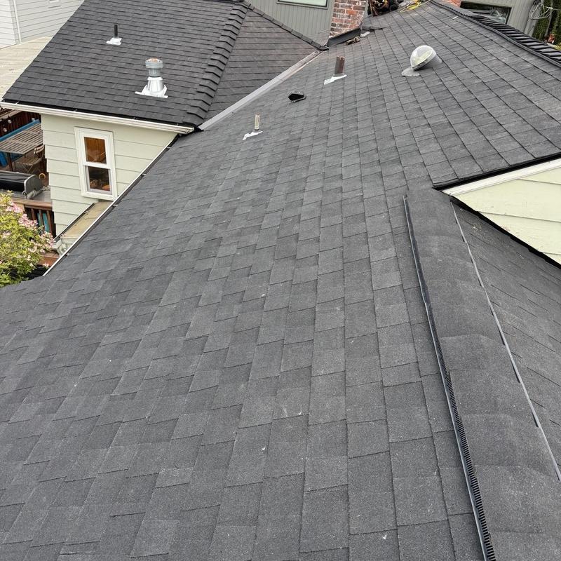 Asphalt shingle roof with vents and skylight installed