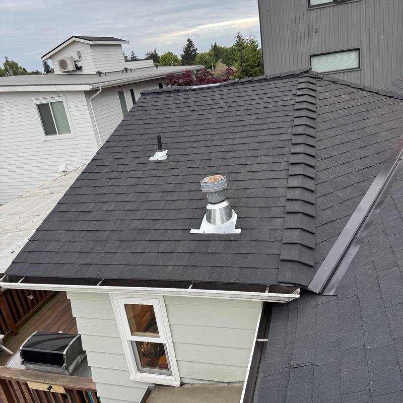 Asphalt shingle roof with vent pipe and ridge cap