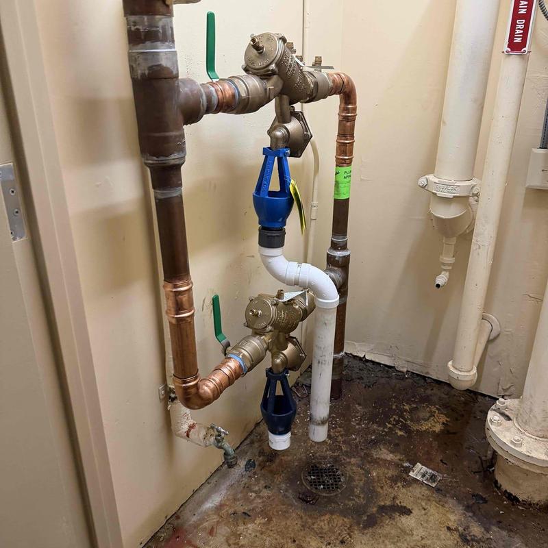 Backflow preventer with copper pipe repairs in utility room