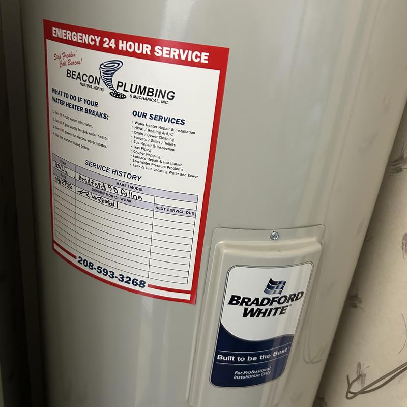 Water heater with Beacon Plumbing service label