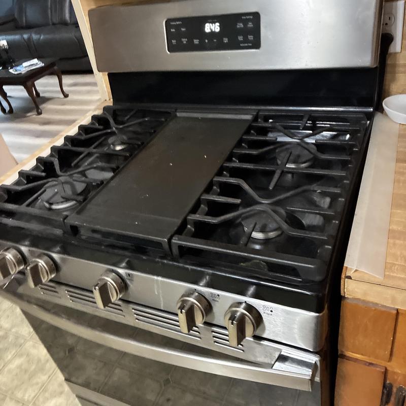 Gas stove with safety-tested burners and controls