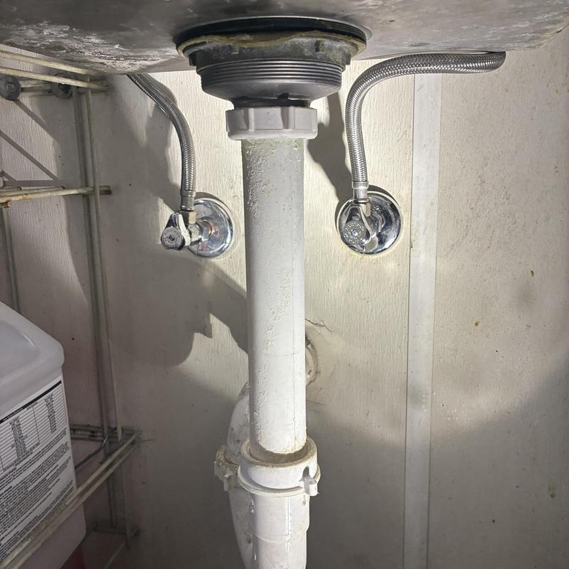 Hot and cold shut off valves under sink with drainpipe