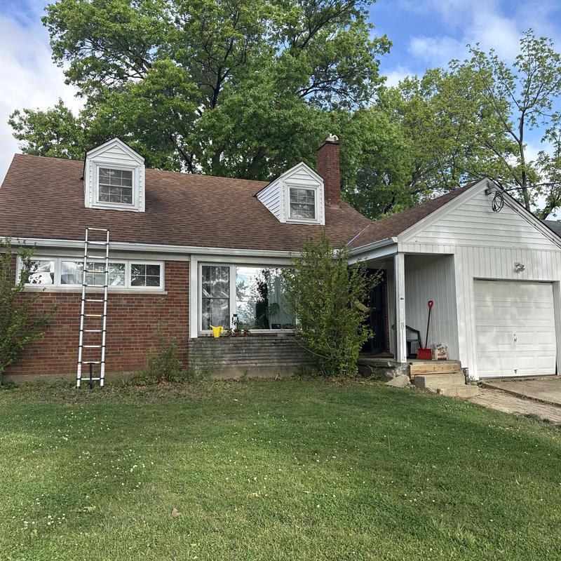 Asphalt shingle roof inspection with ladder on house