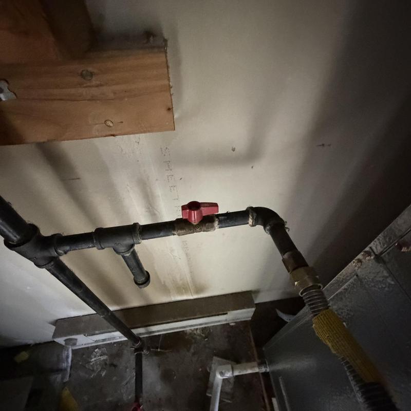 Gas line with red valve in apartment HVAC room