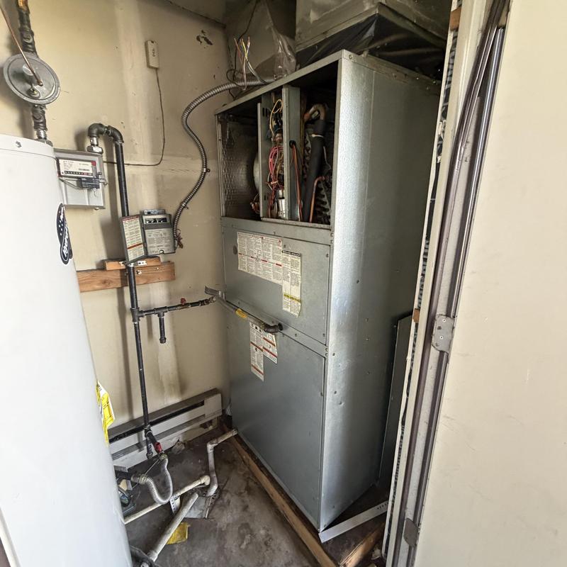 Furnace unit with open panel and exposed wiring