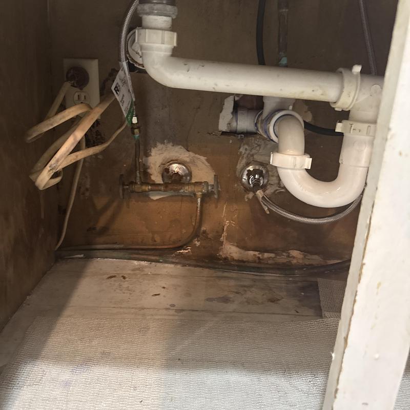 Dishwasher water and drain line plumbing under sink
