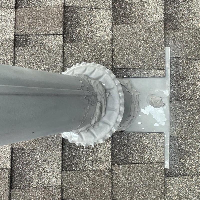 Furnace vent pipe flashing and roof shingle sealing