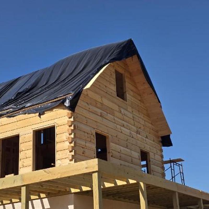 Standing seam metal roof under construction on wood frame Standing seam metal roof under construction on wood frame