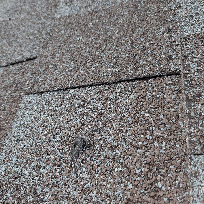 GAF pewter roof shingles with nail pops and damage