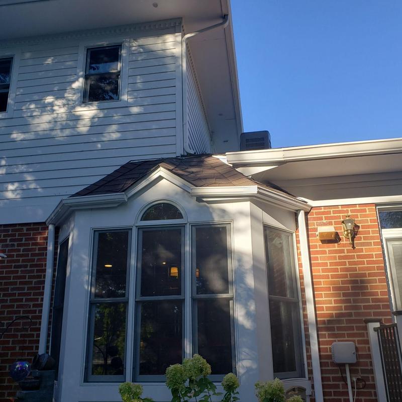 Shingle roof with bay window and brick wall exterior Shingle roof with bay window and brick wall exterior