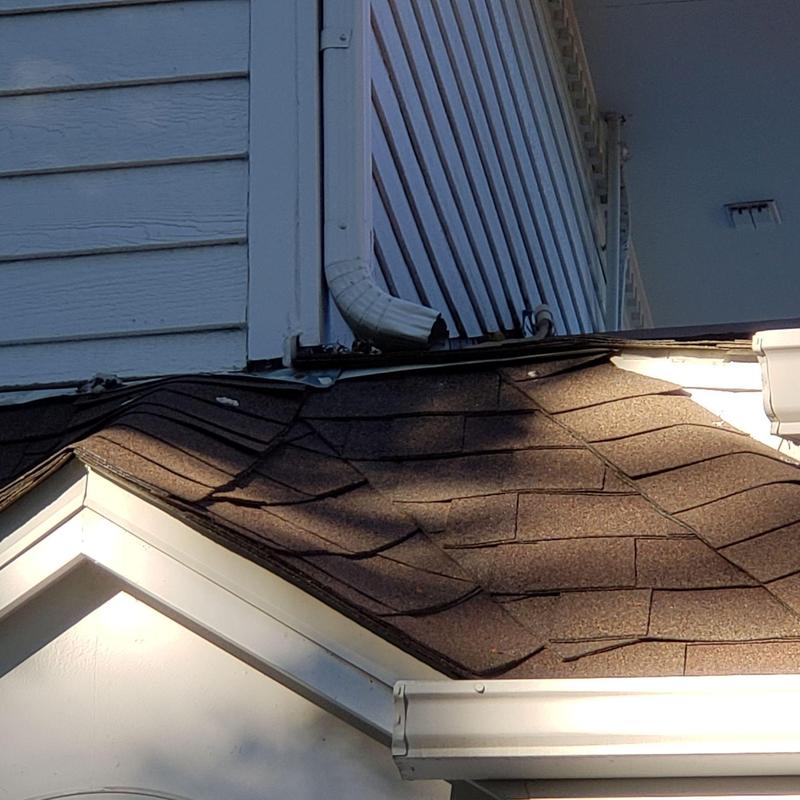 Shingle roof with flashing and gutter corner damage Shingle roof with flashing and gutter corner damage
