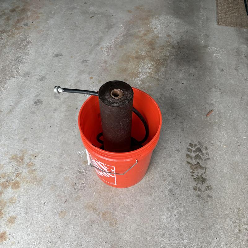Sediment water filter replacement in orange bucket