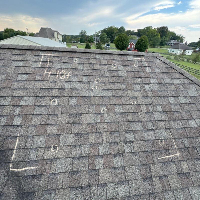 Roof shingles with marked hail damage on residential roof