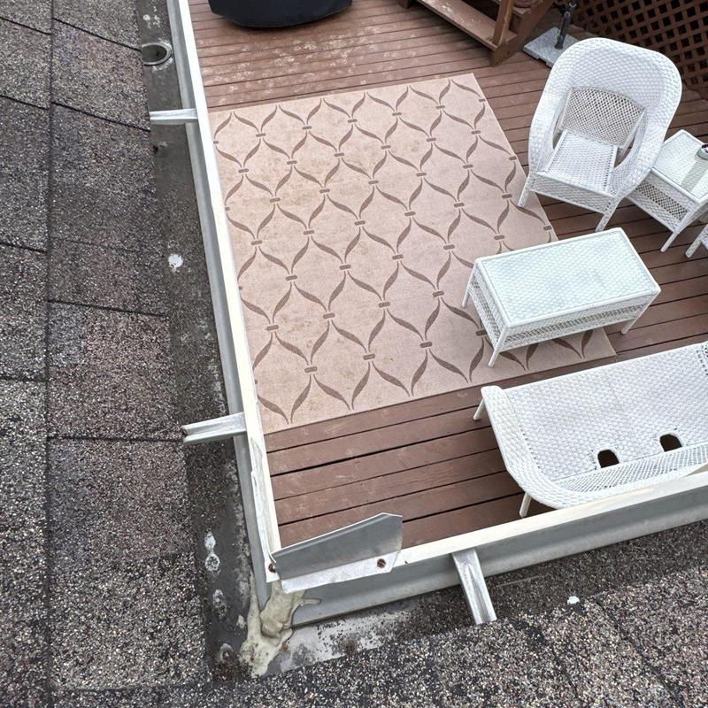 Roof flashing with hail damage near deck furniture