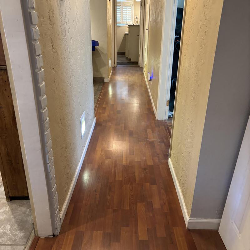 Hallway floor and wall baseboard near plumbing access panels Hallway floor and wall baseboard near plumbing access panels