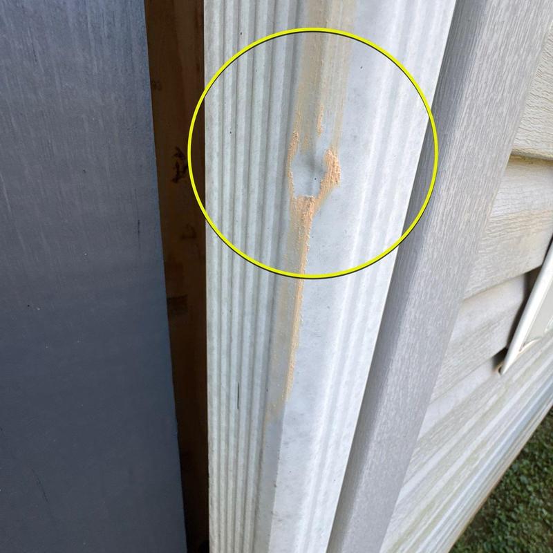 Vinyl siding dent with paint scrape and rust stain