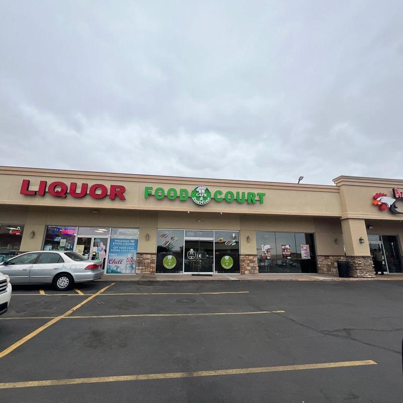 Flat torch-down roof inspection outside food court and liquor store