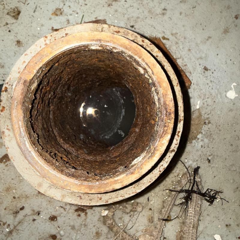 Main sewer line pipe interior with corrosion buildup Main sewer line pipe interior with corrosion buildup