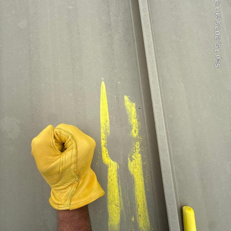 Metal commercial roofing panel with hail damage marks