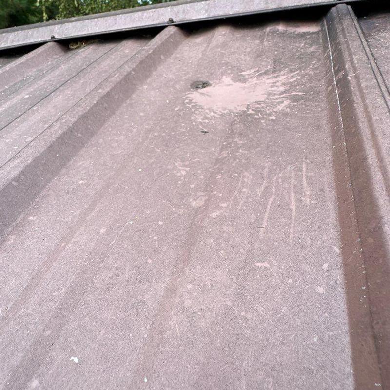 Metal roofing panel with hail damage spotting