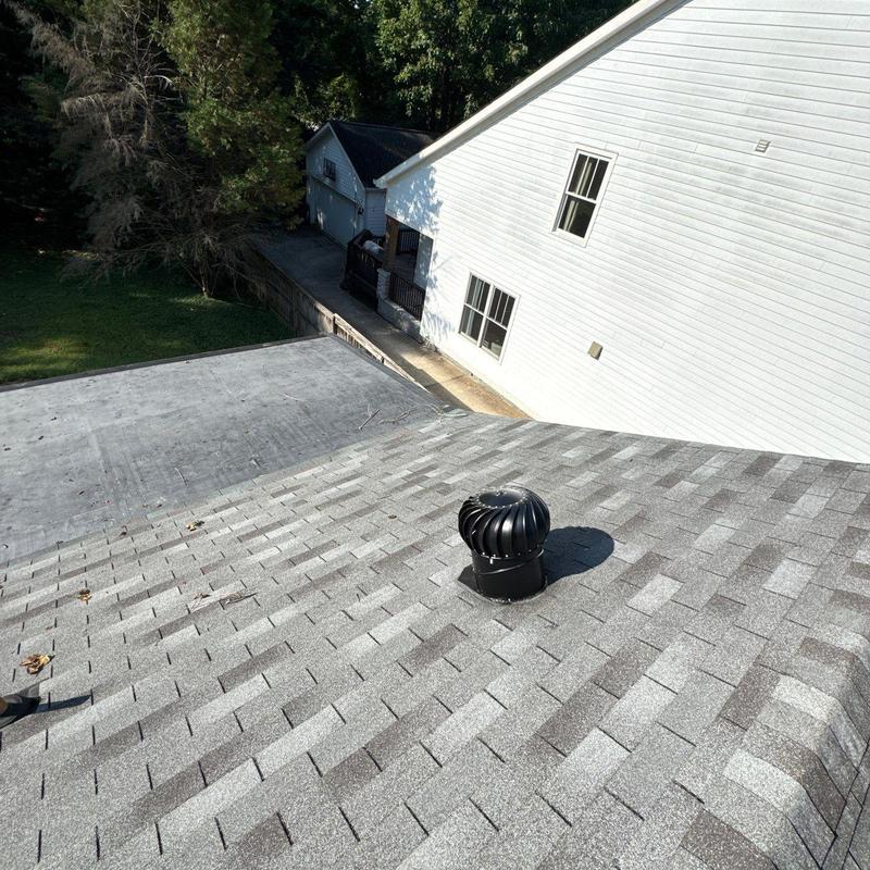 Roof shingles and ventilation turbine on residential roof