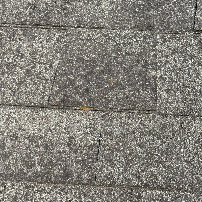 Asphalt shingles with hail damage and wear marks