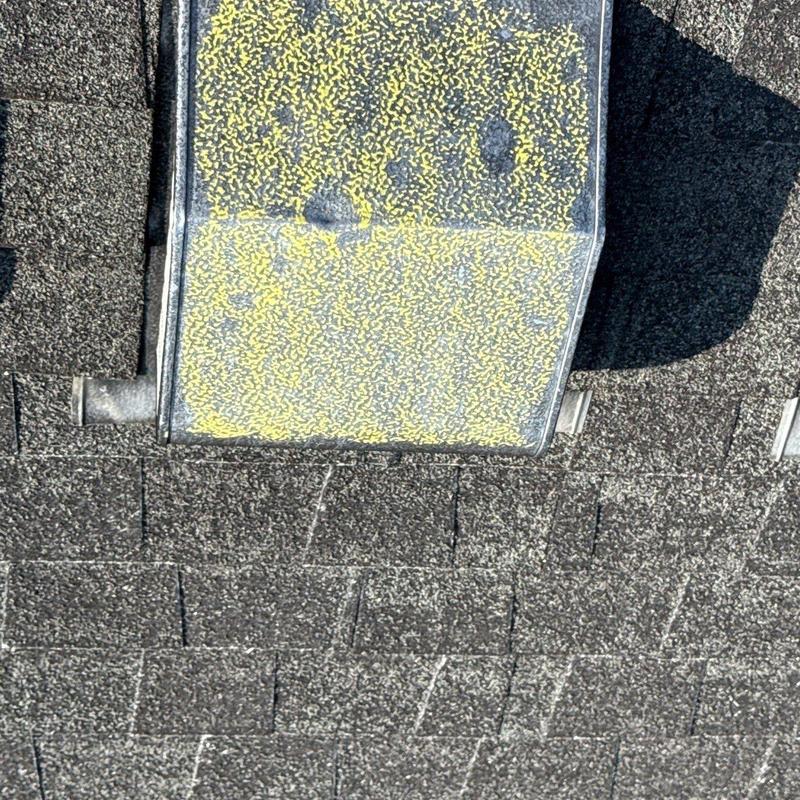 Roof shingles with hail damage near vent cover
