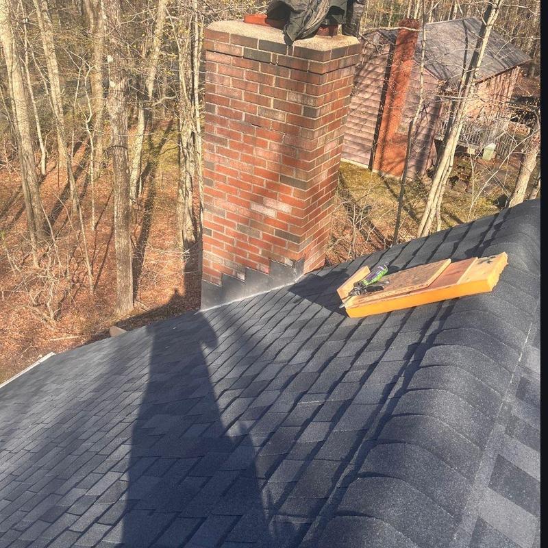 Charcoal black CertainTeed shingles with chimney flashing