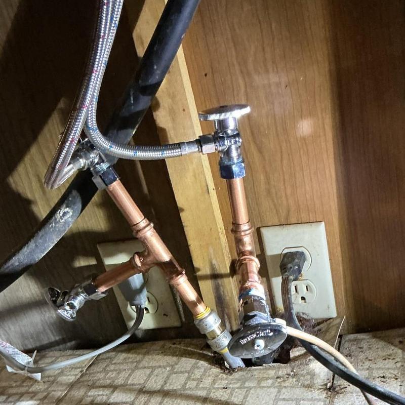 Copper water supply pipes with angle stop valves under sink