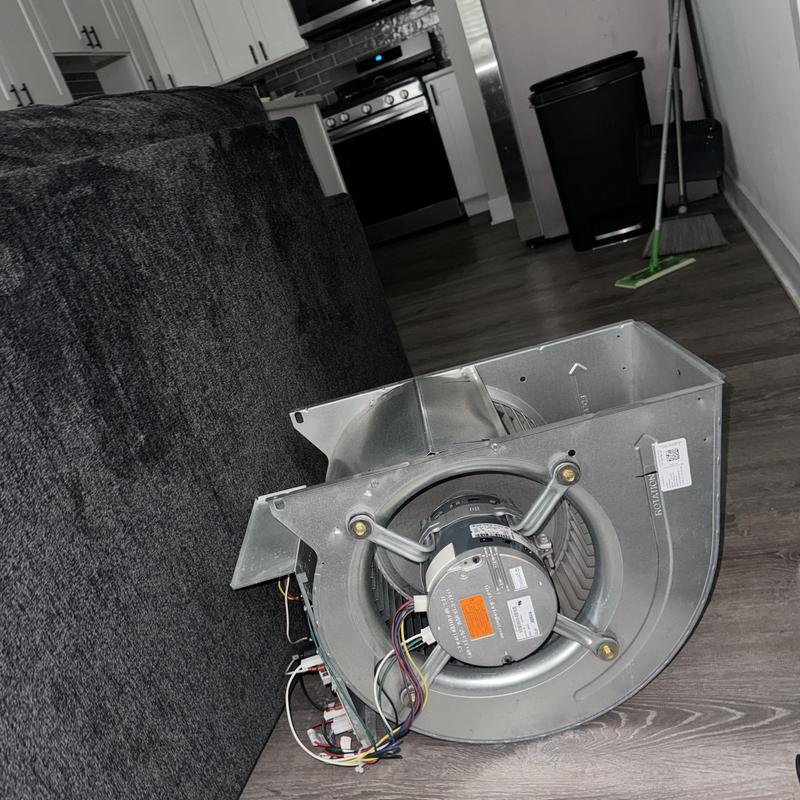 ECM blower motor removed on floor in apartment