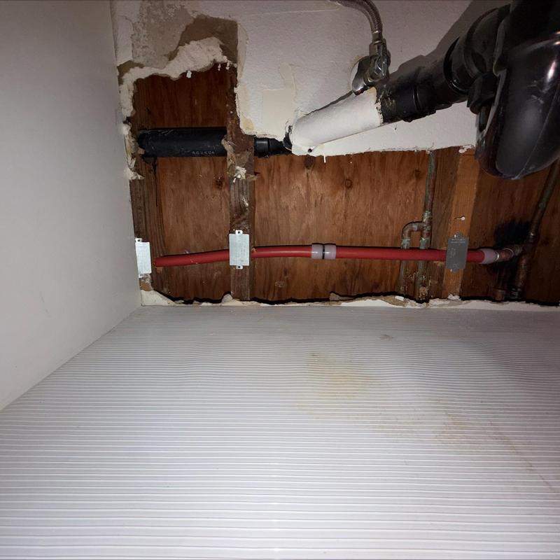 Uponor PEX-A piping installation behind wall panel