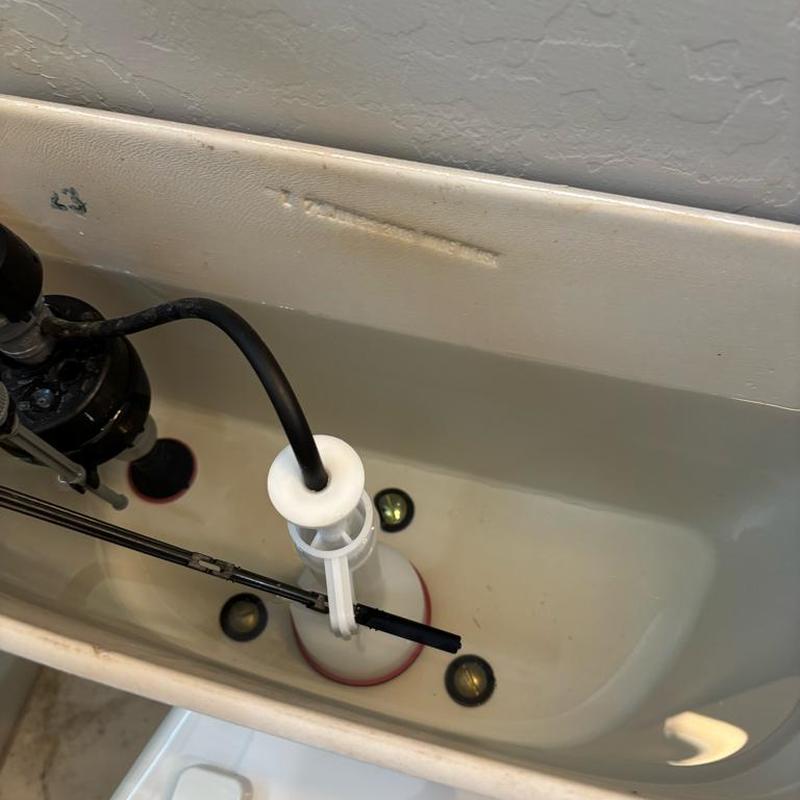 Mansfield flush valve inside toilet tank in bathroom