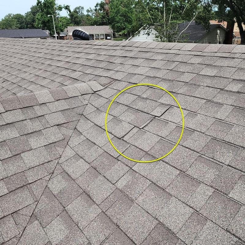 Asphalt roof shingles with installation gap highlighted
