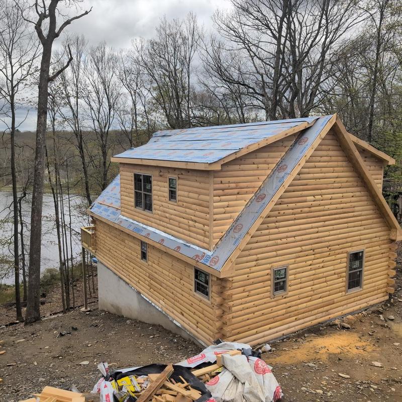 Roof underlayment installation on log cabin roof Roof underlayment installation on log cabin roof