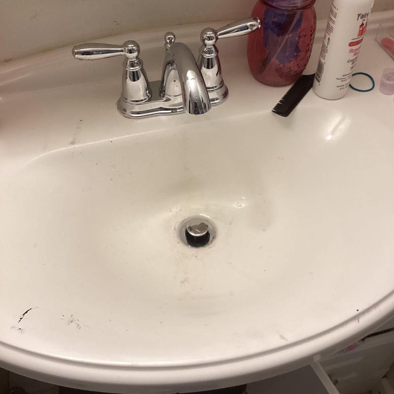 Two-handle lavatory faucet and drain in bathroom sink
