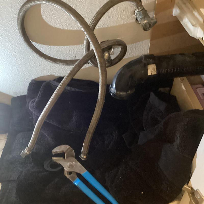 Lav sink braided supply lines and pliers under cabinet