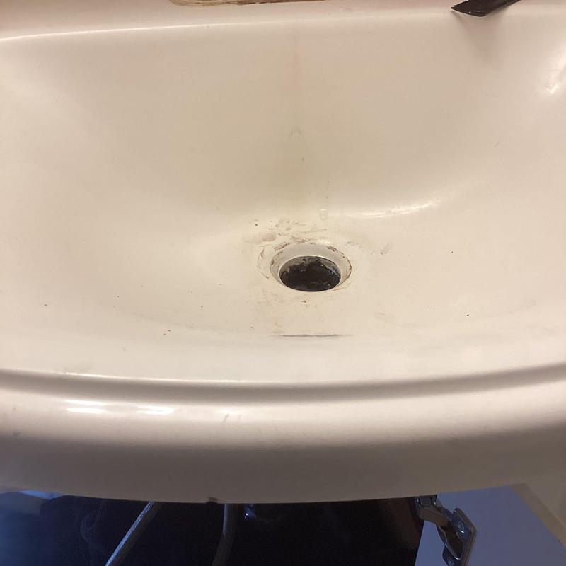 Lav sink drain with visible grime and wear