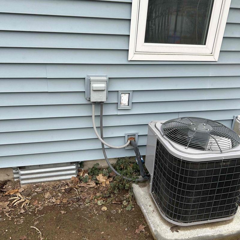Outdoor air conditioner wiring and disconnect box on home exterior