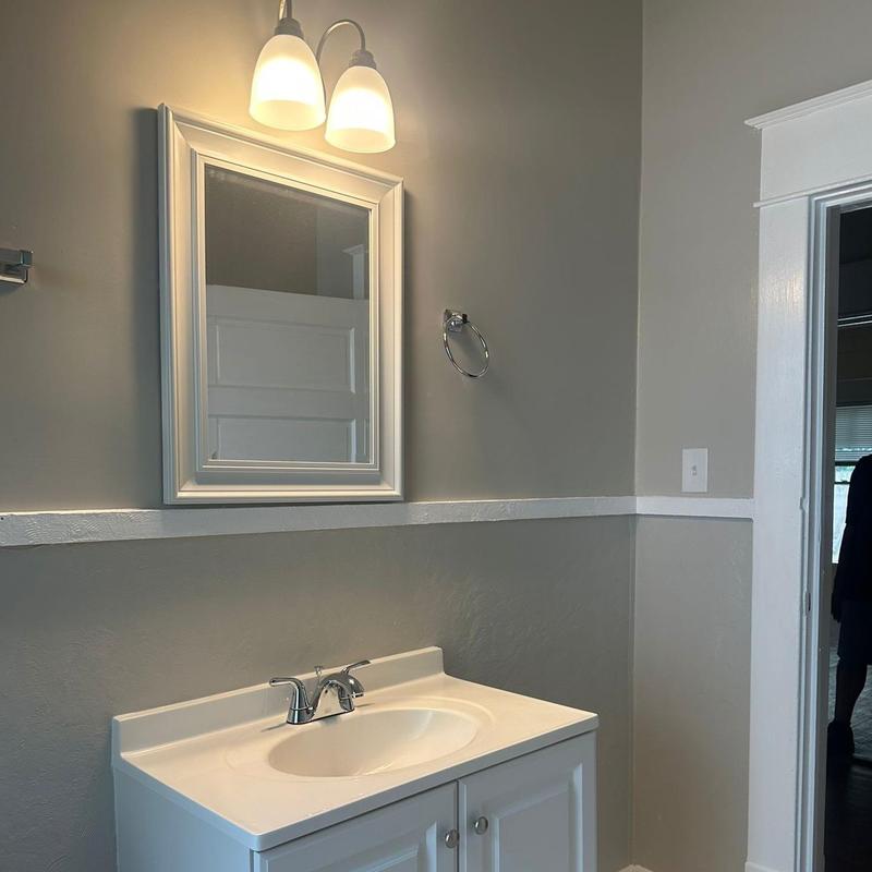 Bathroom vanity with mirror and light fixture