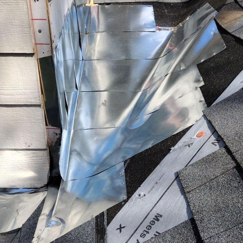 Metal pan flashing and modified base sheet installation on roof