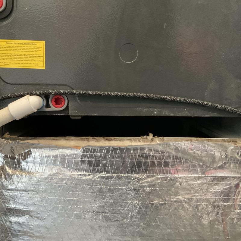 Heat strip assembly inside HVAC unit with insulation wrap