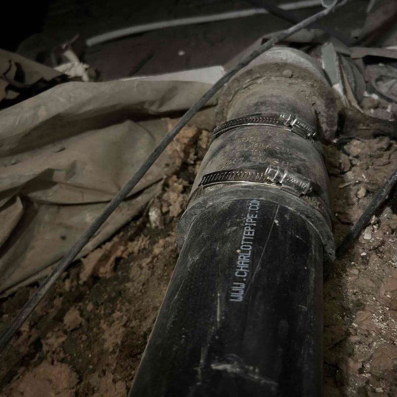 ABS main drain pipe with metal clamps installed