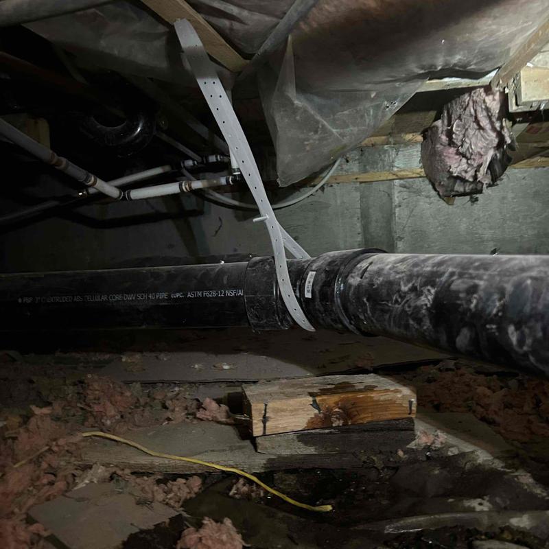 ABS main drain pipe installed and strapped in crawlspace