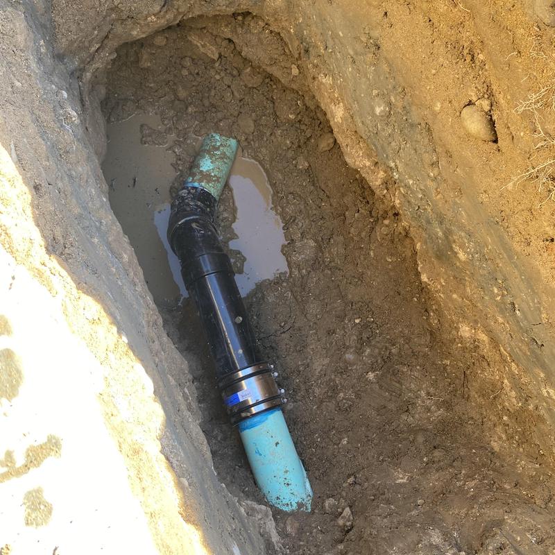 Main sewer line with repair couplings in trench