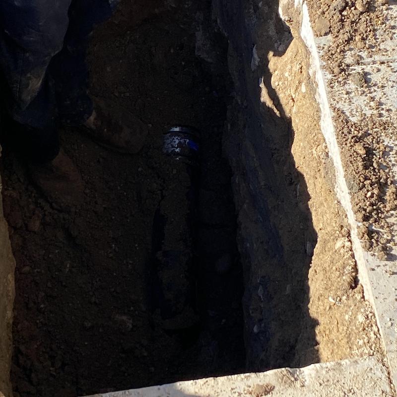 Main line sewer pipe excavation and repair in driveway