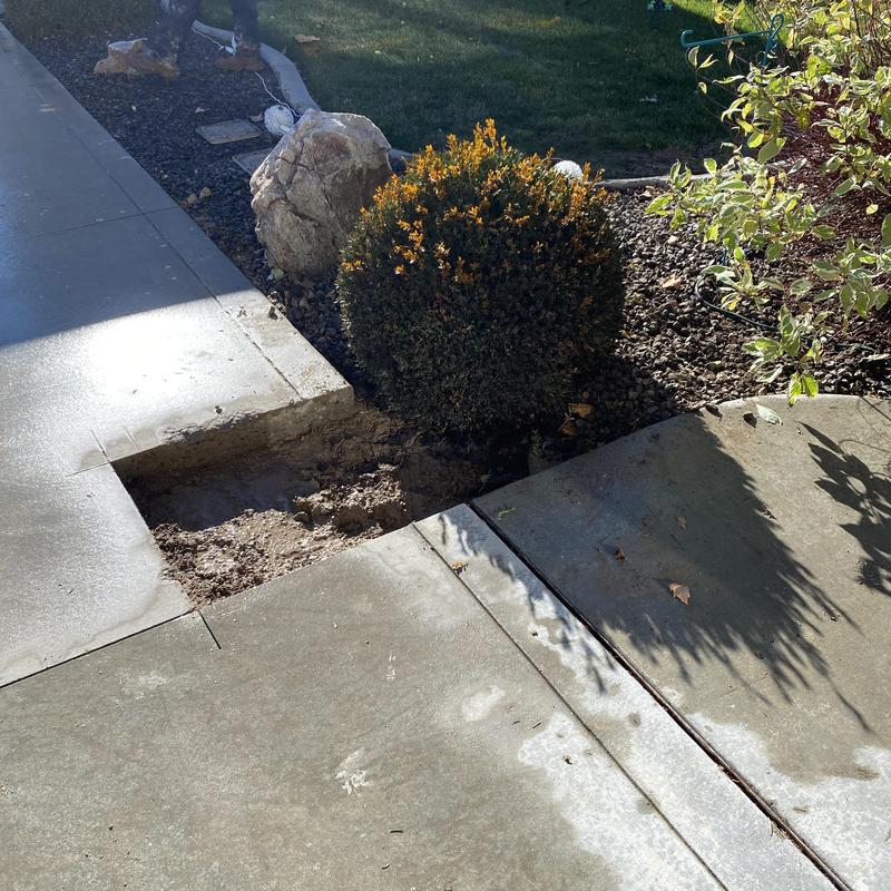 Concrete driveway saw cut and excavation for pipe repair