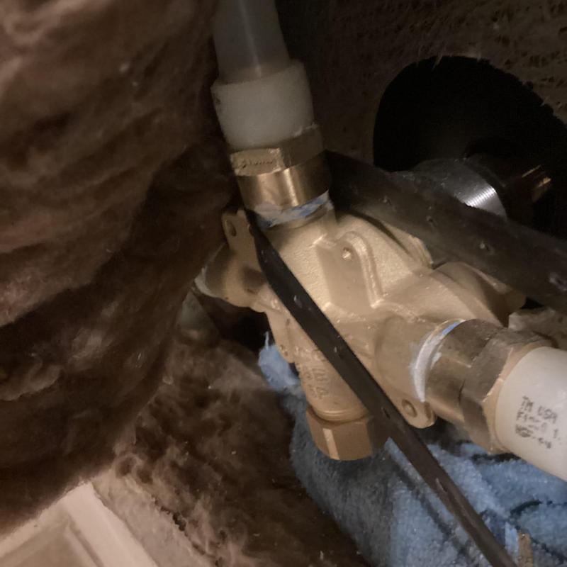 Shower valve replacement behind drywall with plumbing tools