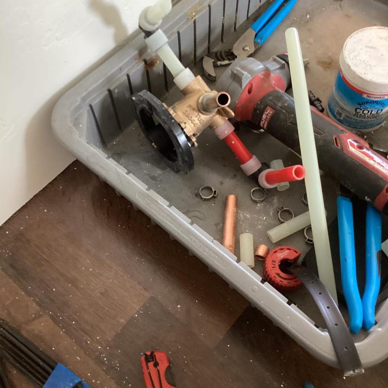 Shower valve and plumbing tools in a work tray