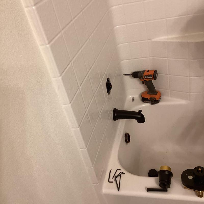 Shower valve replacement with tools in bathtub